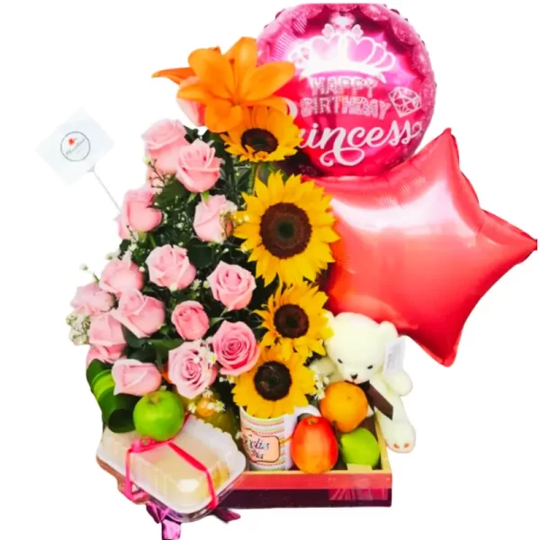 desayuno-sorpresa-con-flores-frutas-y-globos-floristeria-angeluz-cali-colombia Arreglo floral desayuno sorpresa con rosas rosadas, girasoles, globo de "Happy Birthday Princess", globo de estrella, oso de peluche, frutas frescas (manzana, naranja) y porción de pastel, ideal para cumpleaños.